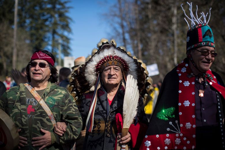 Hereditary Chief Phil Lane Jr., center, joins other indigenous chiefs and elders in leading thousands of people in a march during a protest against the Kinder Morgan Trans Mountain pipeline expansion in Burnaby, British Columbia, Saturday, March 10, 2018. (Darryl Dyck/The Canadian Press via AP)