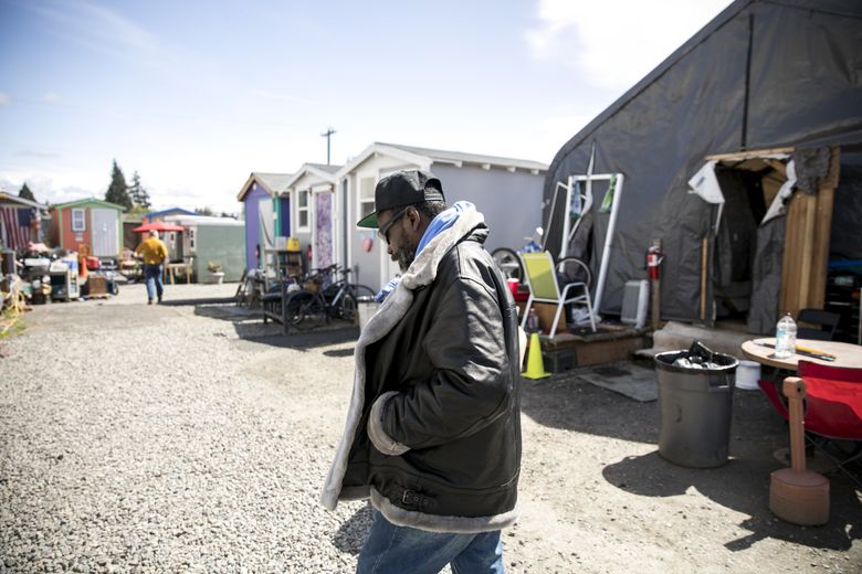 Darryl Taylor, 55, lives at Licton Springs Village, a tent and tiny-house encampment where residents can use drugs and alcohol. “It helped me turn my life around,” said Taylor, who lost two toes and part of his finger to frostbite while living on the streets of Seattle. “It kind of saved me.” (Bettina Hansen/The Seattle Times)