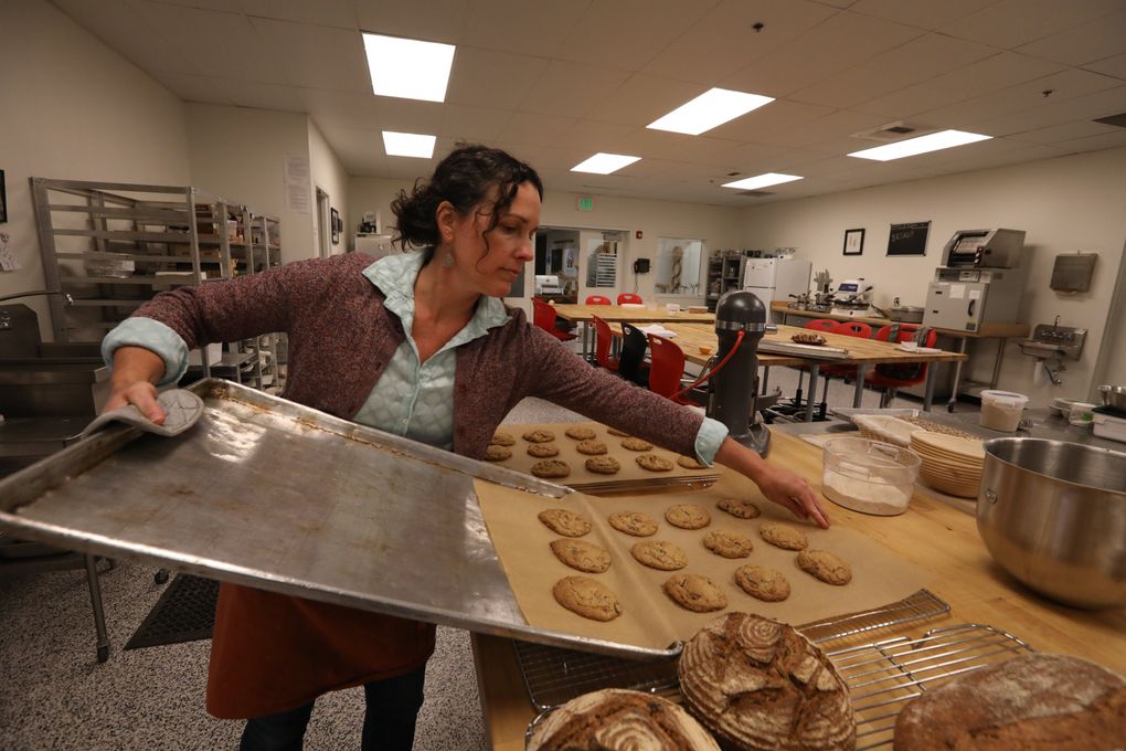 Kim Binczewski, managing director of WSU’s Bread Lab in Burlington, has just baked a batch of chocolate-chip cookies for a visiting class from Mount Vernon High School. (Alan Berner/The Seattle Times)