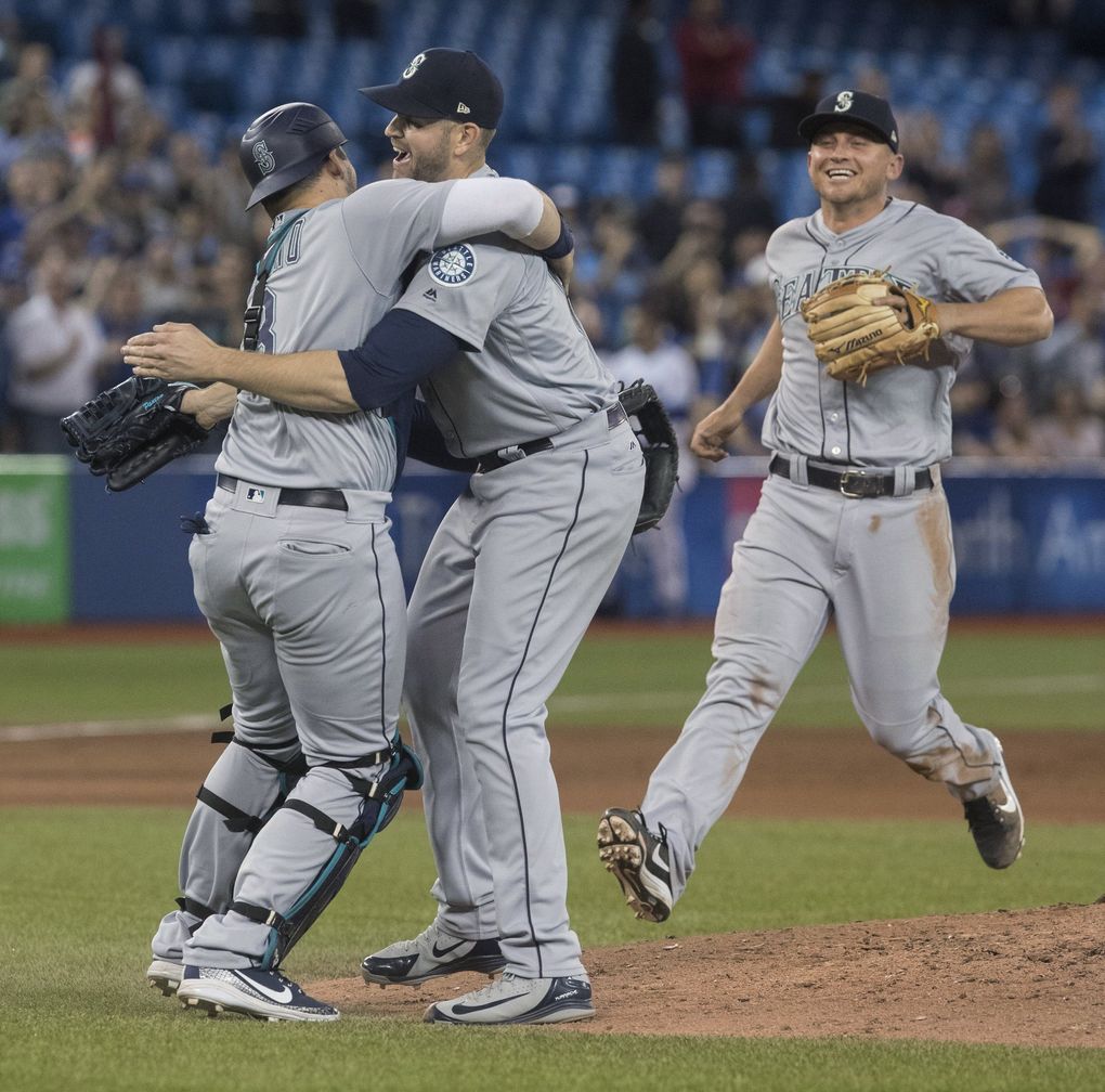 Seattle Mariners starting pitcher James Paxton, center, celebrates with teammates after throwing a no-hitter against the Toronto Blue Jays in a baseball game Tuesday, May 8, 2018, in Toronto.  (Fred Thornhill / The Associated Press)