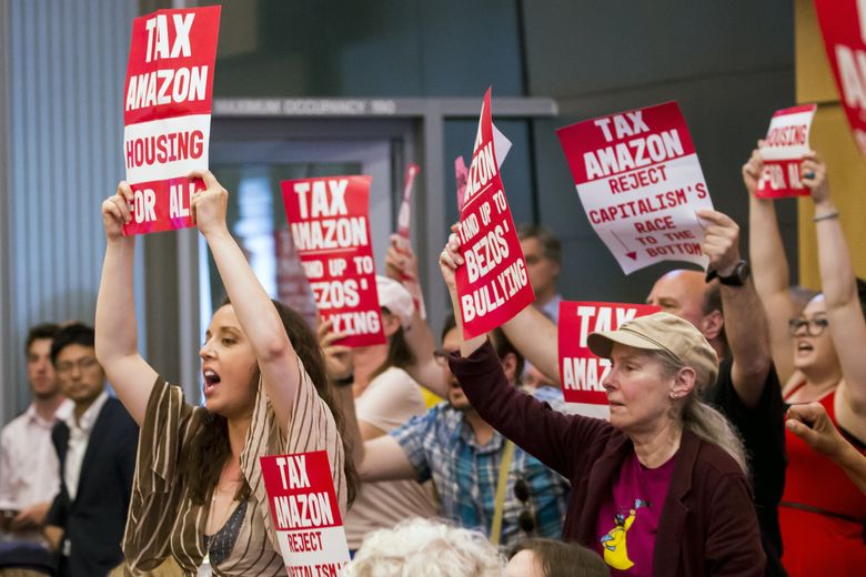 Supporters of a head tax cheer as the Seattle City Council prepares to vote Monday. Amazon became a kind of symbol during weeks of discussion on the head tax. Some people said big businesses ought to pay a new tax to help address the homelessness crisis, while others worried about an anti-business message. (Bettina Hansen/The Seattle Times)