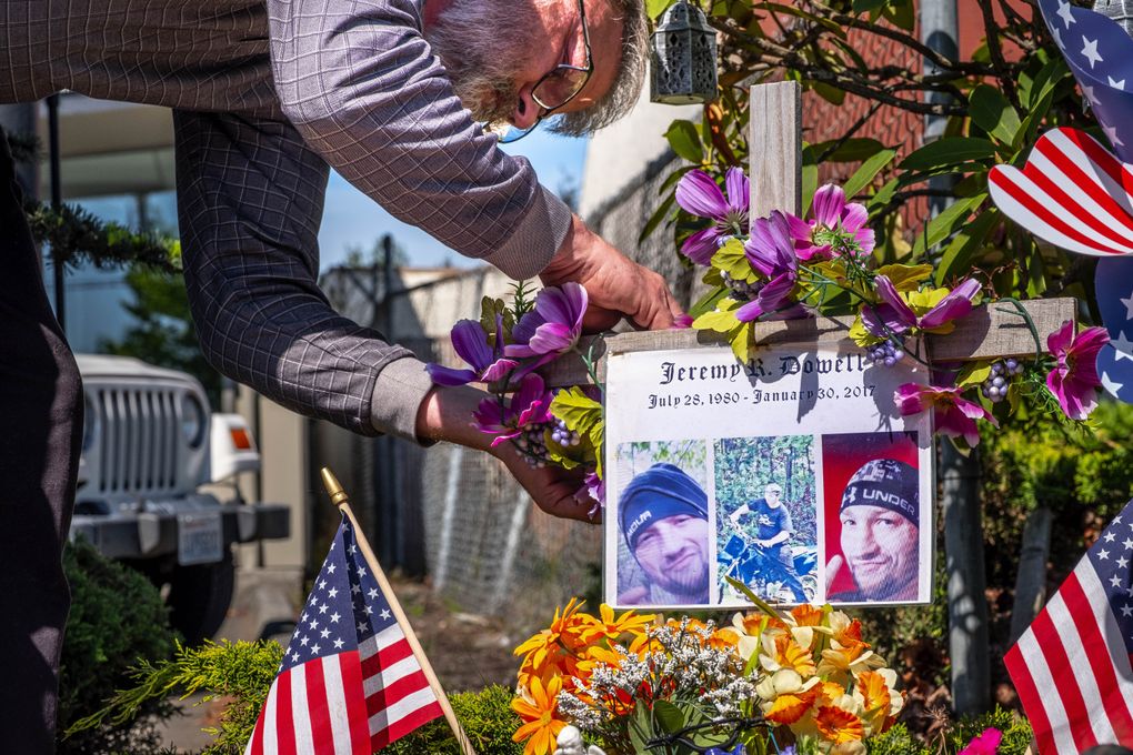 Bob and Suzette Dowell have been maintaining a memorial for their son, Jeremy Dowell, near the spot where he was shot and killed by a Lynnwood police officer in January 2017. On Monday, they filed a federal lawsuit against Officer Zachary Yates, claiming the shooting was not justified.  (Dean Rutz/The Seattle Times)