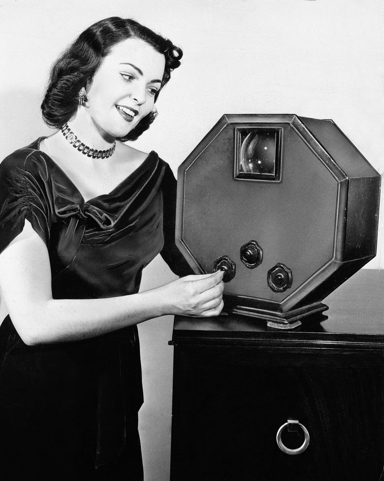 Marjorie Adams, Miss Chicago of 1950-51, demonstrates a GE television with a 3-inch screen in Chicago in 1952.  Photograph: General Electric/Associated Press.