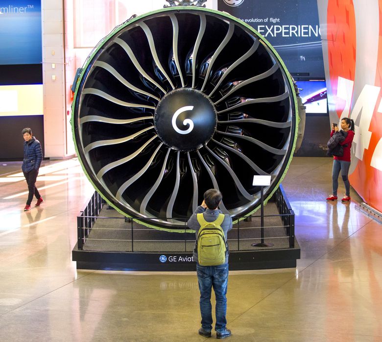 Visitors to The Future of Flight Aviation Center in Mukilteo are dwarfed by the giant GE-90 jet engines used on the Boeing 777.  Photograph: Mike Siegel/The Seattle Times.