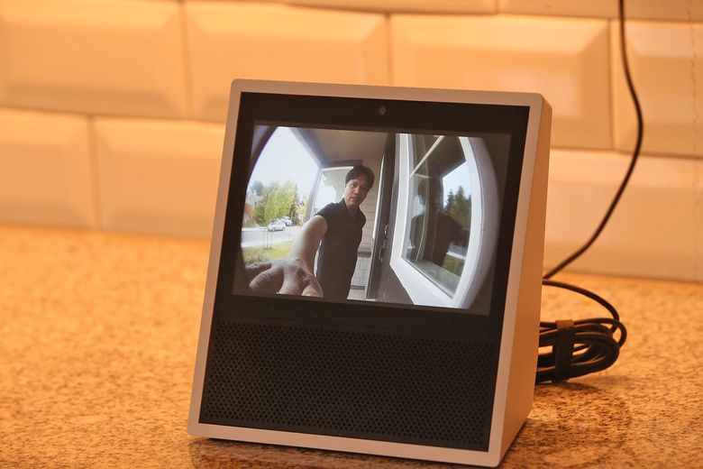 Arnold Rosales is visible on the Amazon Echo “Show” screen via the front-door camera inside the door bell.  (Greg Gilbert/The Seattle Times)