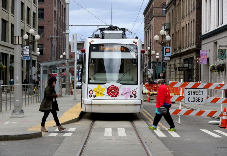 A streetcar sits idle while its operator is on break at the S. Jackson St. terminus, with utility construction in progress in the background, Tuesday, March 13, 2018 in Seattle’s Pioneer Square neighborhood.  (Ken Lambert/The Seattle Times)
