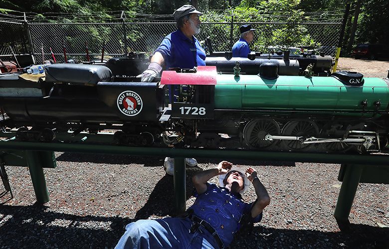 Ken Olsen (CQ) troubleshoots a problem with his scale model of a Great Northern steam engine, checking under the firebox.   Behind him are engineers Chris Haaland (CQ) and Don Deffley.

Northwest Wanderings
Steam engines, mainly, and more.

Sat. July 14, 2018