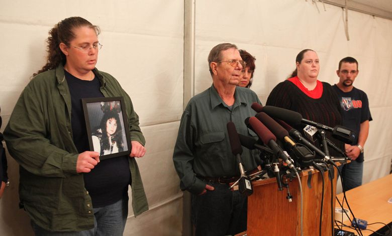 Speaking after witnessing the execution of Cal Brown is the victim's father, John Washa Jr. who described his feelings of closure and love that he has for his murdered daughter, Holly Washa. At left, holding Holly's photo, is sister Karen Washa. Behind John is family friend Kim Bowen. To her right is sister Beckey Washa and at the far right is an unidentified family friend. — Photograph: Steve Ringman/The Seattle Times.
