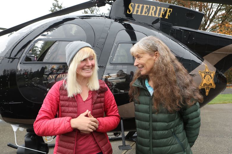 Rescued hiker Katharina Groene, left, smiles when Nancy Abell jokes that daughters give their mothers gray hair at a news conference in Snohomish. Groene credits Abel with saving her life, as Abell called 911 when she saw how bad conditions were on the Pacific Crest Trail where Groene was hiking.
 (Ellen M. Banner / The Seattle Times)