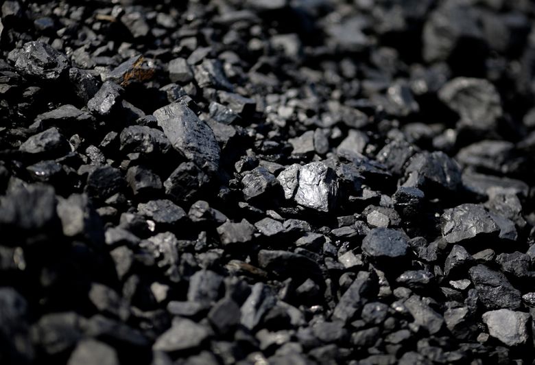 In this May 22, 2014, file photo, sunlight reflects off of a chunk of coal at Dominion Terminal Associates' coal terminal in Newport News, Virginia. — Photograph: Patrick Semansky/Associated Press.