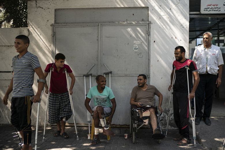 In this Sept. 10, 2018, photo, patients with leg injuries from demonstrations gather outside a clinic run by MSF (Doctors Without Borders) in Gaza City. (Felipe Dana / The Associated Press)