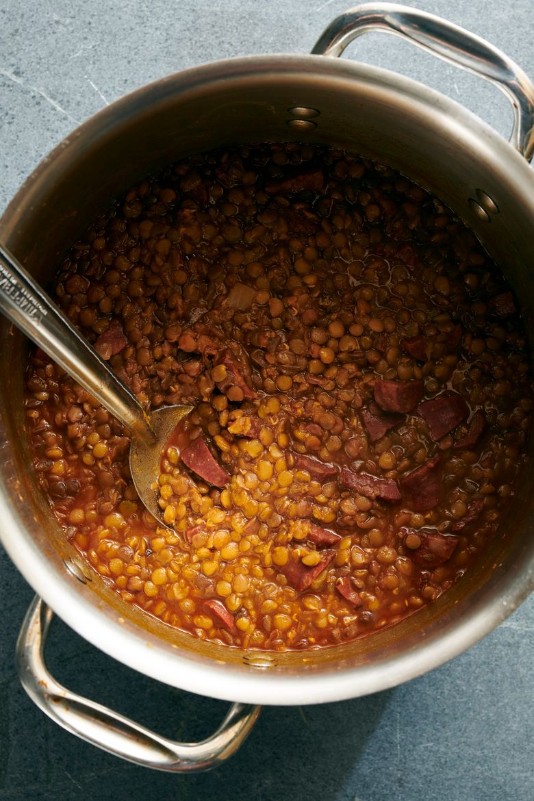 Lentils are prepared with chorizo, greens and yellow rice.  (David Malosh/The New York Times)