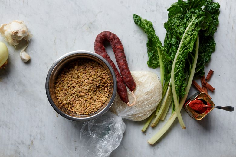 Ingredients for lentils with chorizo, greens and yellow rice.  (David Malosh/The New York Times)
