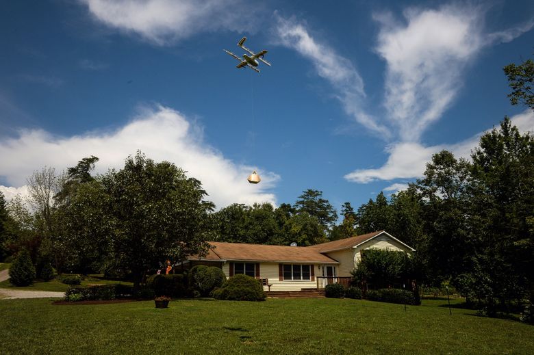 A drone from Alphabet’s Project Wing unit delivers a package at a home during a demonstration in Blacksburg, Virginia, last year. (Charles Mostoller / Bloomberg)