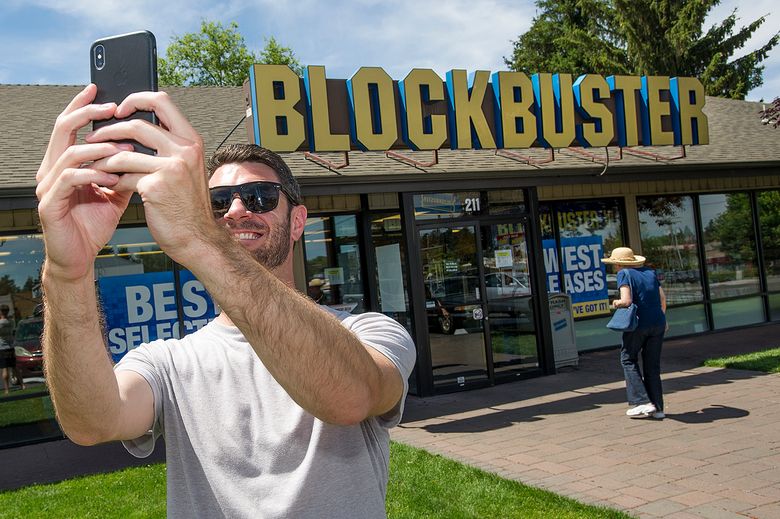 Scott Thornton takes a selfie last year in front of the Bend, Ore., Blockbuster. The store became the last one in the U.S. last year, and now it’s the only one in the world. (Ryan Brennecke / The Bulletin via AP, file)