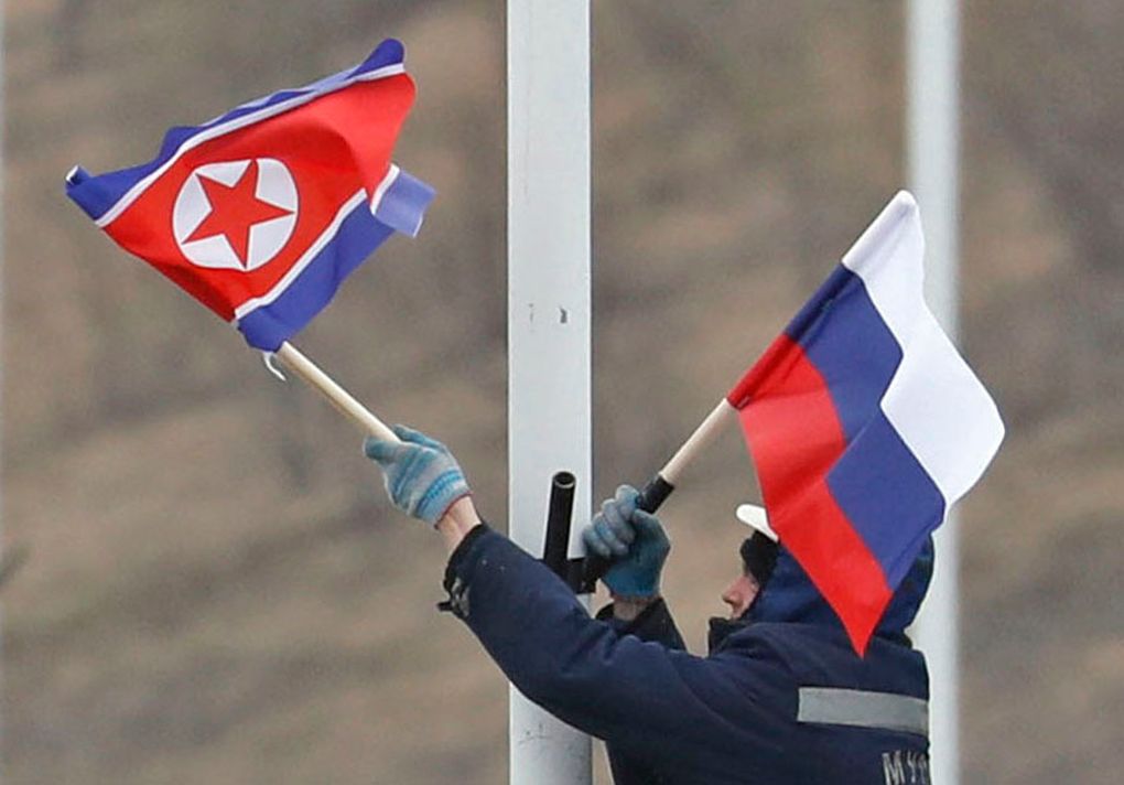 A worker adjusts the flag of Russia and North Korea along the road in Russky Island, off the southern tip of Vladivostok, on Tuesday, April. 23, 2019. Preparations are underway for a summit between the leader of North Korea and Russia's president, Russian officials and media reported on Tuesday. Russian media have widely reported that the leaders will meet in the port city of Vladivostok on the Pacific Ocean. — Photograph: Naoya Osato/Kyodo News/via Associated Press.
