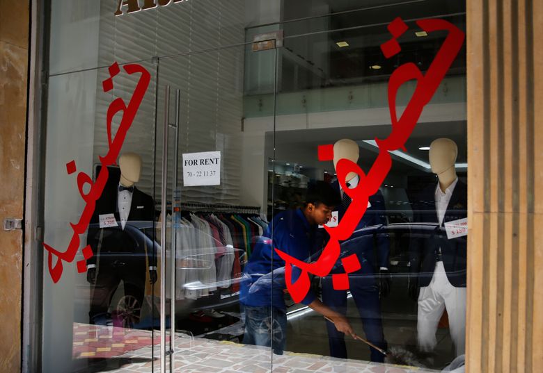In this Thursday, July 18, 2019 photo, a worker cleans a display in shop with Arabic on the window that read: âLiquidationâ and âthe shop is for rent,â in Hamra street, Beirut, Lebanon. As the economic crisis deepens in Lebanon, so has the publicâs distrust in the ability of the old political class, widely viewed as corrupt and steeped in personal rivalries, to tackle major reform. Many fear a Greek-style bankruptcy, without the European Union to fall back on, and with a potentially more violent social unrest in the small country wedged between war-torn Syria and Israel. (AP Photo/Hussein Malla)