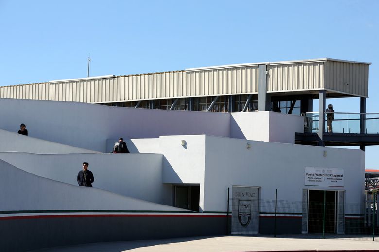 People walk up a ramp at the El Chaparral pedestrian border crossing in Tijuana, Mexico. Asylum-seekers can apply to enter the U.S. at this location. (Erika Schultz / The Seattle Times)
