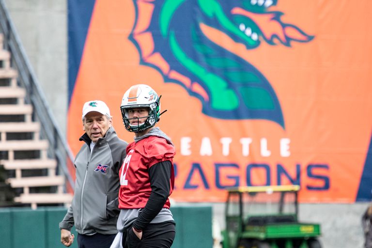 XFL Seattle coach Jim Zorn stands next to QB Brandon Silvers as the Dragons have a practice open to the public on Saturday, Dec. 14 at Memorial Stadium in Seattle. (Jane Gershovich / Courtesy Seattle Dragons)