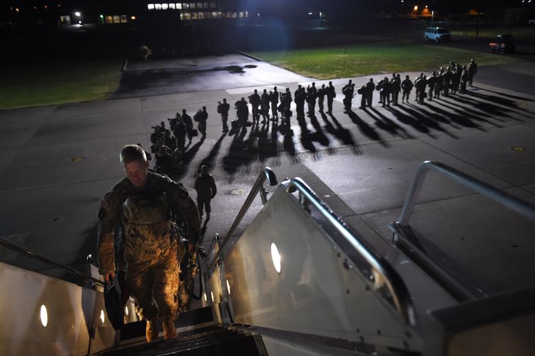 U.S. Army personnel board a plane for a deployment to Afghanistan from Fort Campbell, Ky., on Nov. 6, 2014. (Washington Post photo by Matt McClain).