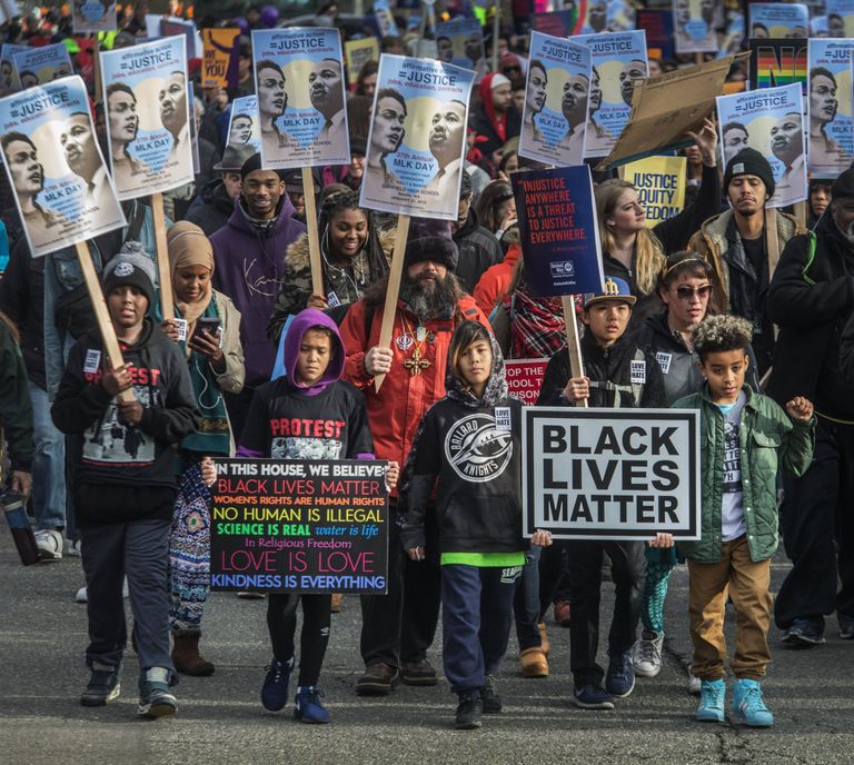 Children take the lead of last year’s Martin Luther King Jr. march as it heads up Union Street toward downtown. (Steve Ringman / The Seattle Times, file)