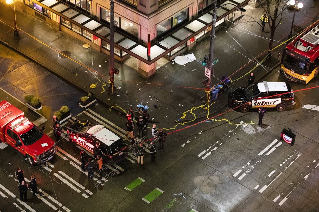 Police work a crime scene after the shooting near Third Avenue and Pine Street in downtown Seattle on Wednesday. (Amanda Snyder / The Seattle Times)
