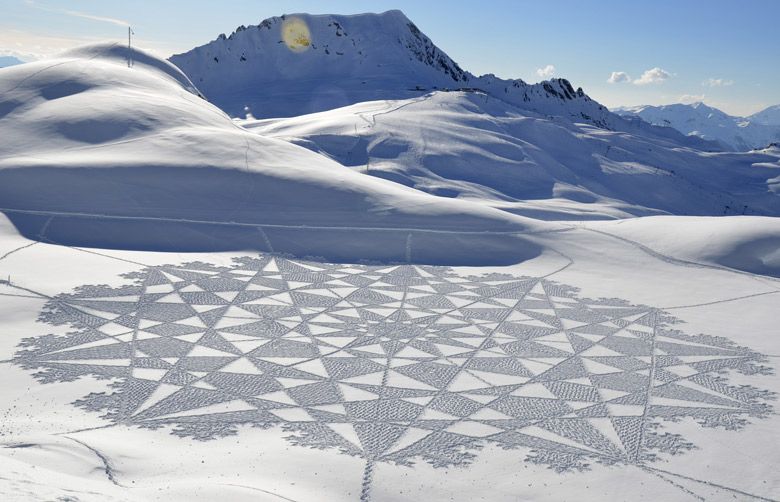 Artist uses snow as canvas for massive geometrical designs