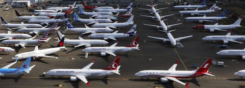 Grounded 737 MAX passenger planes crowded the south end of Boeing Field in September. The MAX crisis has focused new attention on the company’s board of directors, which oversees management. (Alan Berner / Seattle Times)