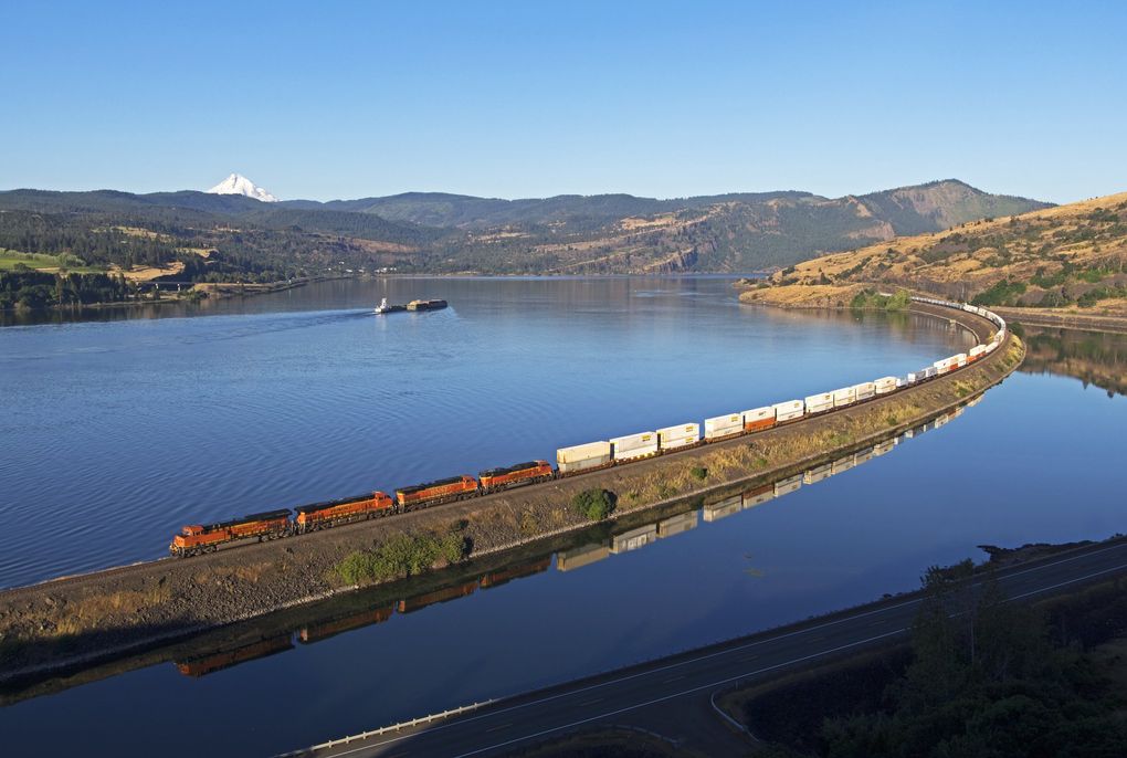 A BNSF Railway train moves east through the Columbia River Gorge near Lyle, Klickitat County. BNSF is one of the largest railroads operating in the Pacific Northwest, with 1,335 miles of track in Washington state where it employs more than 4,000 people. (Justin Franz)