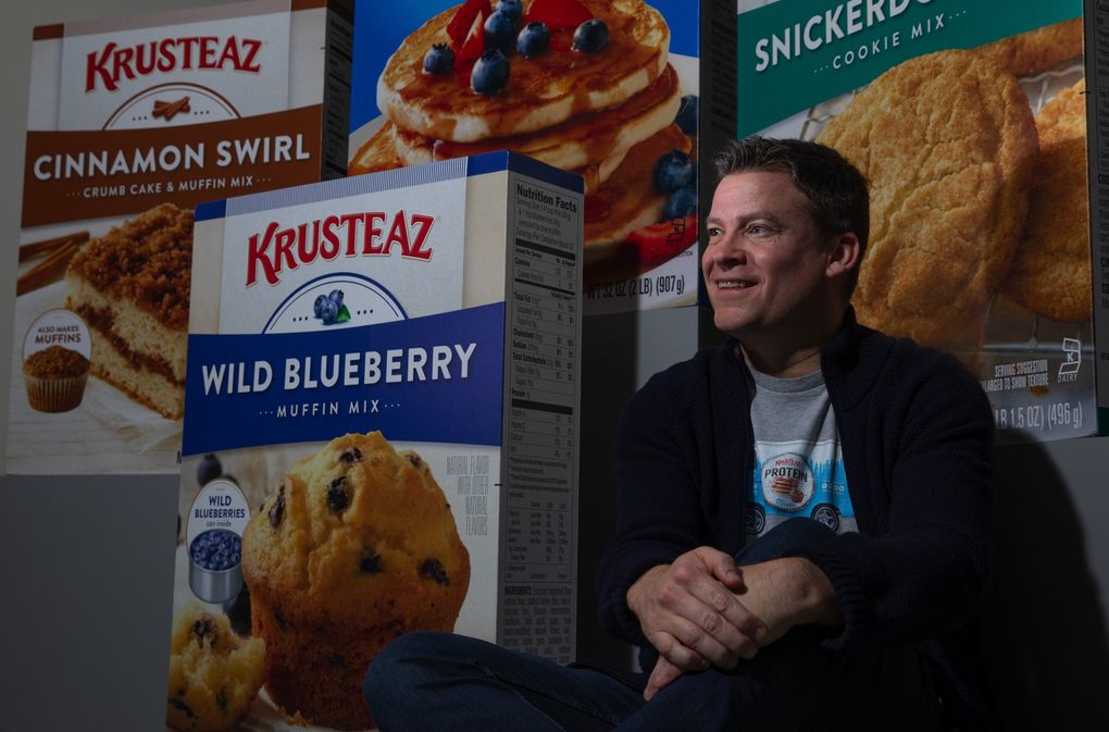 Andy Heily, CEO of Continental Mills (which makes Krusteaz food items), sits near boxes of items produced at the company's Tukwila headquarters last month. Seattle's Krusteaz started in the early 1930s and has been operated by the Heily family for three generations. (Ellen M. Banner / The Seattle Times)