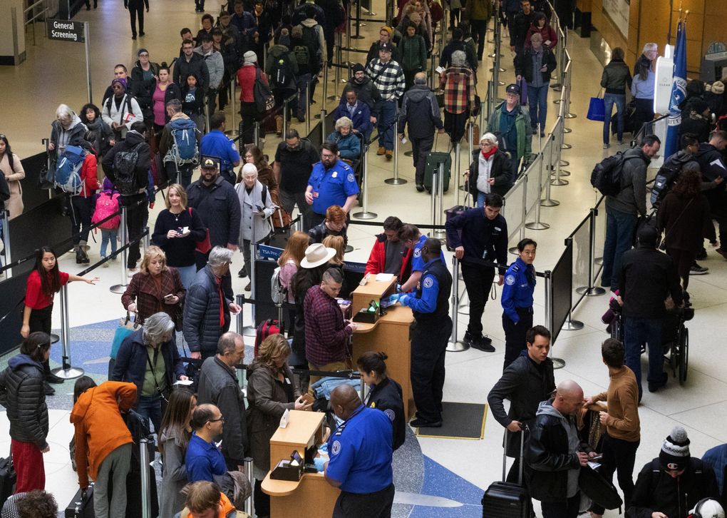 Passengers stand in long lines at the Seattle-Tacoma International Airport  in December.   (Ellen M. Banner / The Seattle Times)