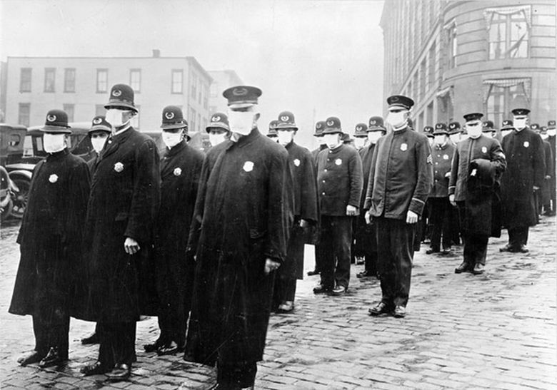 Police officers in Seattle wear masks made by the Red Cross, during the influenza epidemic in December 1918. (National Archives)