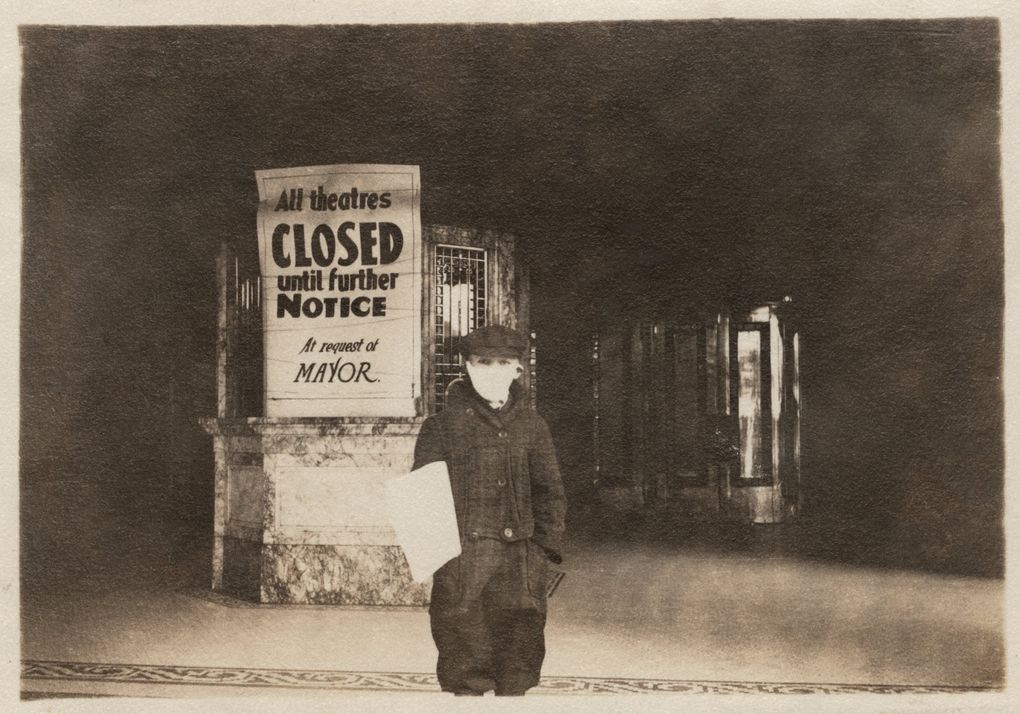 Youth stand in front of a downtown Seattle theater that closed after Mayor Ole Hanson’s proclamation concerning public gatherings in 1918\. (Museum of History &amp; Industry, Seattle)