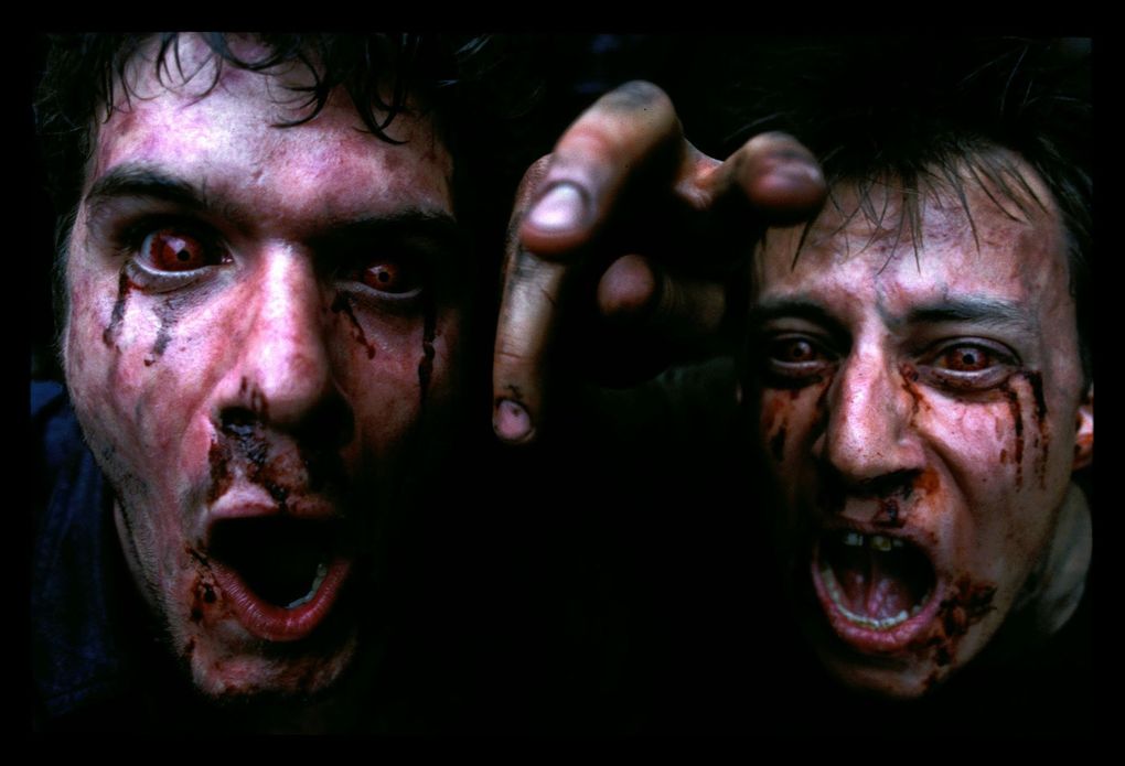 Zombies rant on the set of the horror film “28 Days Later,” in this undated promotional photo. Many movies about zombies also carry social commentary hidden beneath the horror. (Peter Mountain / The Associated Press)