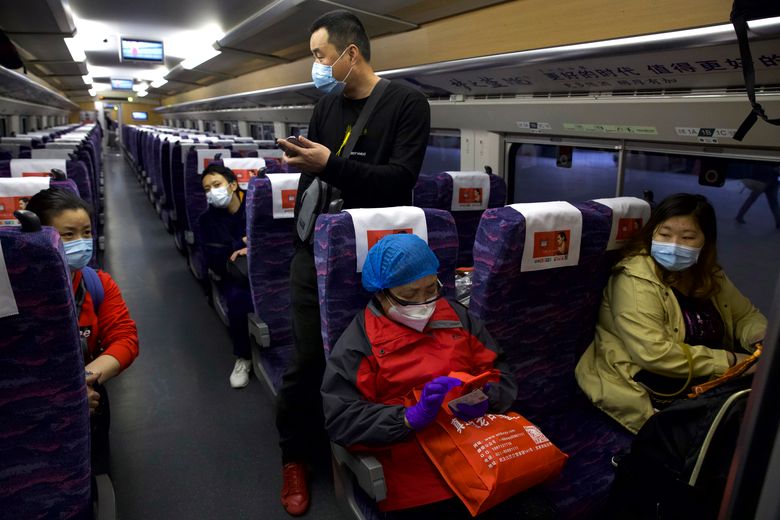 Masked crowds fill streets, trains after Wuhan lockdown ...