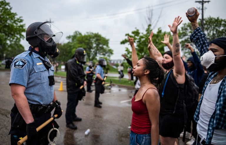 Protesters and police face each other during a rally for George Floyd in Minneapolis on Tuesday, May 26, 2020. Four Minneapolis officers involved in the arrest of the black man who died in police custody were fired Tuesday, hours after a bystander’s video showed an officer kneeling on the handcuffed man’s neck, even after he pleaded that he could not breathe and stopped moving. (Richard Tsong-Taatarii/Star Tribune via AP) 