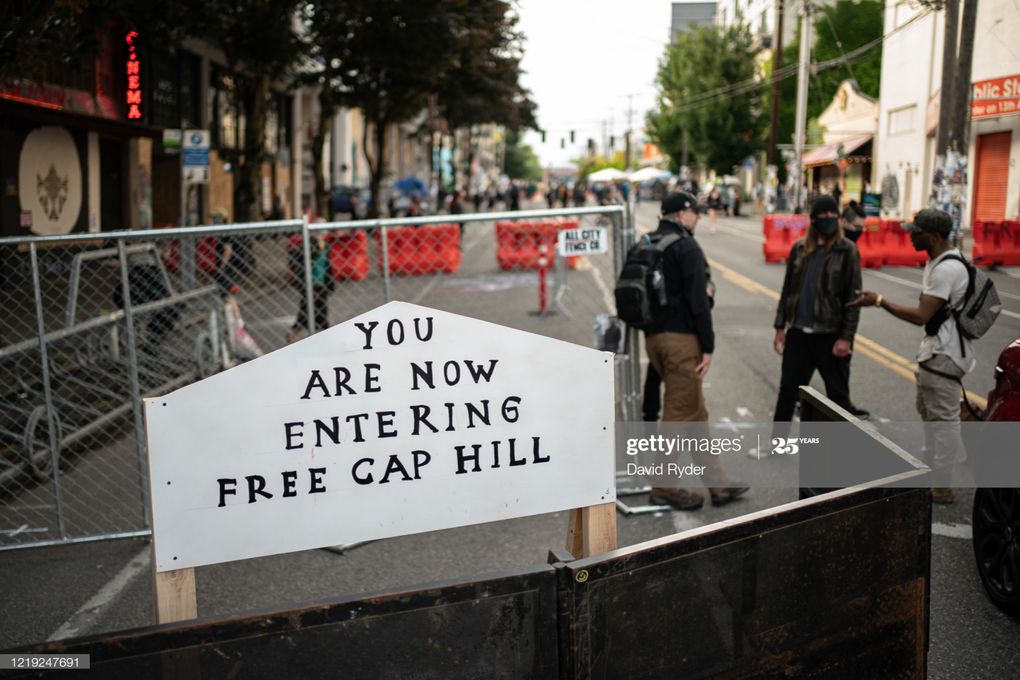 ORIGINAL IMAGE: This June 10 image shows a sign on a barrier at the Capitol Hill Autonomous Zone (CHAZ). It was used in the creation of digitally manipulated images published by Fox News. (Photo by David Ryder/Getty Images)