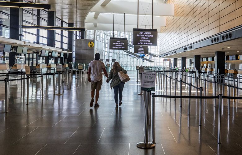 Sea-Tac Airport passenger volume is still far below its pre-pandemic peaks. But it has grown from the low volumes of this spring, as seen in this May photo. (Steve Ringman / The Seattle Times)
