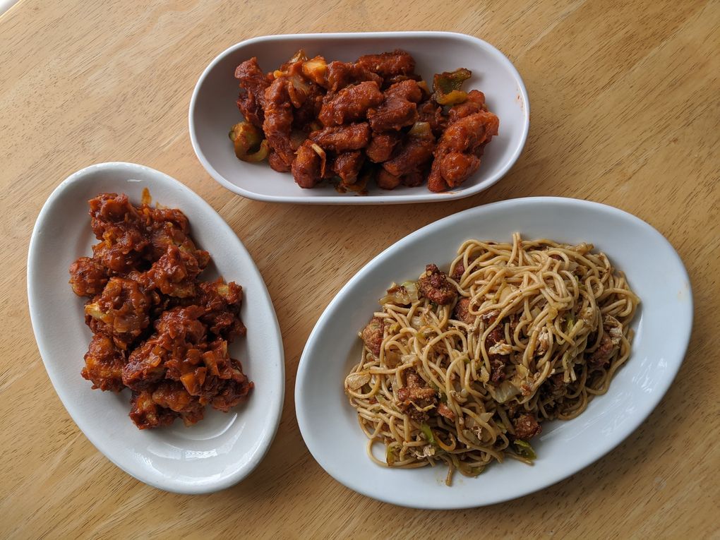 The Gobi Manchurian, left, and chilli baby corn at Kirkland’s Cafe Bahar feature a delicious sour, spicy sauce our writer couldn’t get enough of. (Jackie Varriano / The Seattle Times)