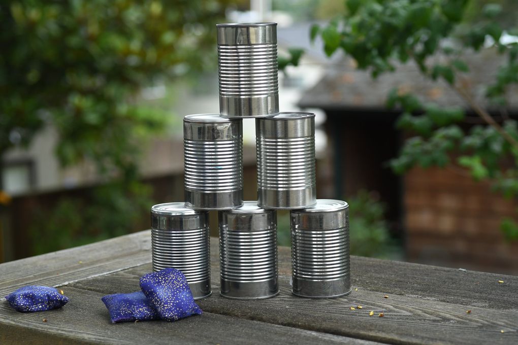 Create a tin-can pyramid and see how many you can knock over. (JiaYing Grygiel)