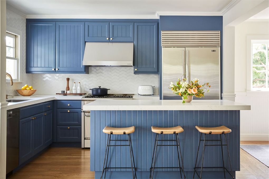 A custom kitchen, like this one by Caitlin Jones Design, features cabinets built to fit your exact needs and spacing, and can also be a playground for design. Here, the owners chose beadboard cabinet fronts painted in Benjamin Moore Newburyport Blue.(Courtesy of Vivian Johnson for Caitlin Jones Design)