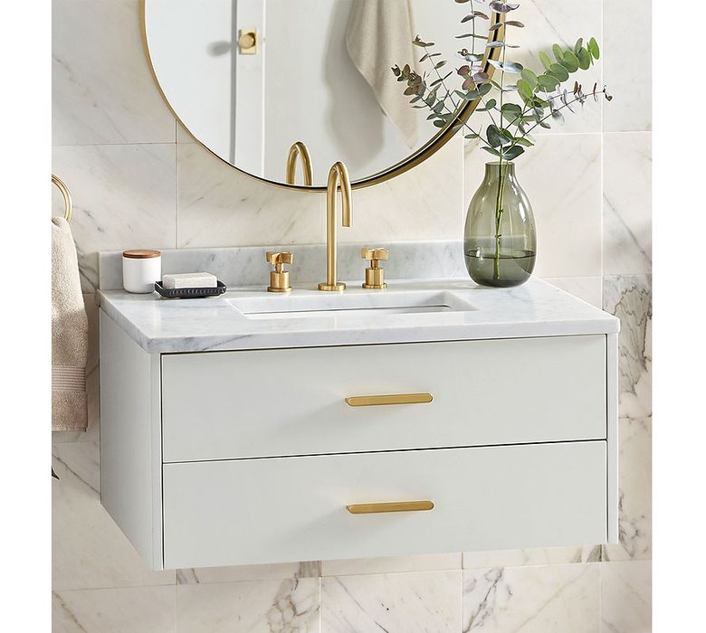 For countertops, opt for marble or a marble-look material, such as this Carrara marble top on the Rejuvenation Geneva Wall Mount Powder Vanity. (Courtesy of Rejuvenation)