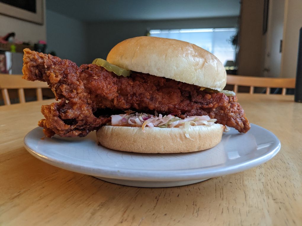 The small chicken sandwich at Yummy Meats & Deli features an almost comically large chicken tender, dredged in mouth-tingling Sichuan peppercorns. (Jackie Varriano / The Seattle Times)