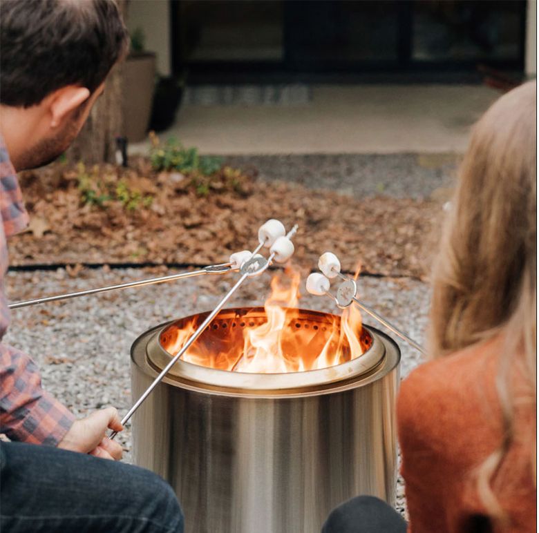 A fire pit provides warmth, 
and roasting sticks provide a comforting activity as cooler weather arrives. (Courtesy of Solo Stove)
