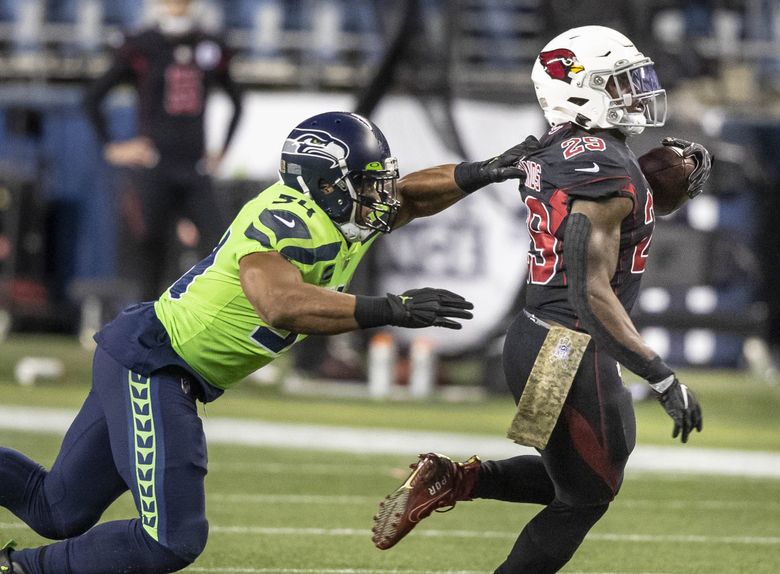 Bobby Wagner gets called for the horse collar tackle of Arizona’s Chase Edmonds in the 3rd quarter. (Dean Rutz / The Seattle Times)
