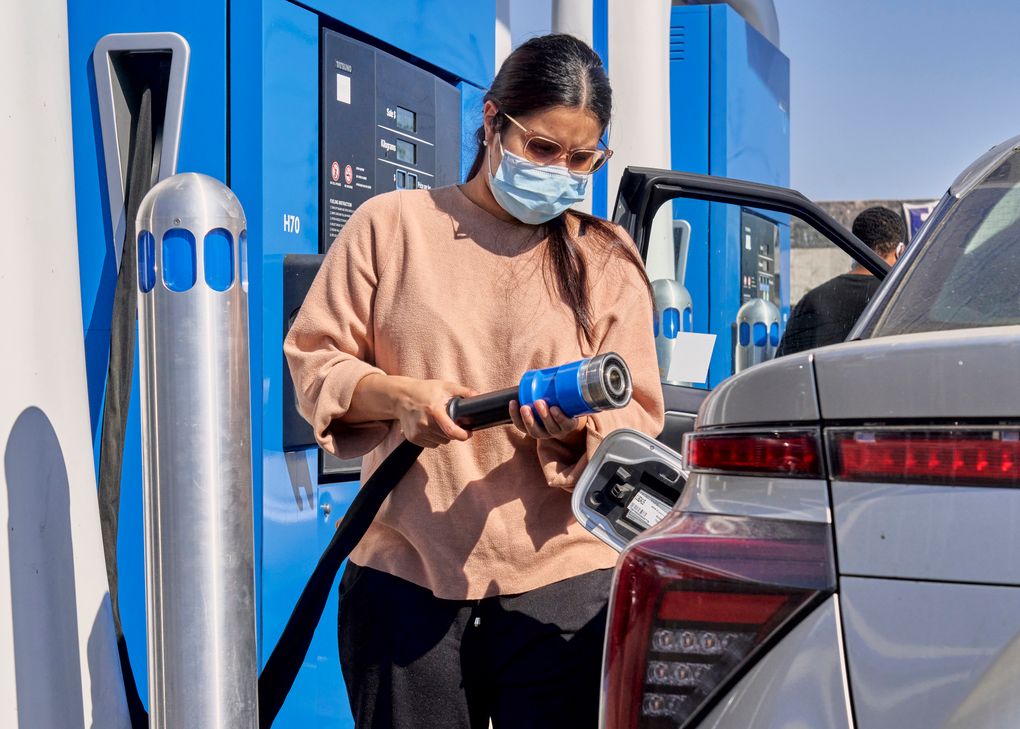 A motorist fills a Toyota Mirai, a hydrogen-powered car, at a gas station in Fountain Valley, Calif., Oct. 14. (Philip Cheung/The New York Times)
