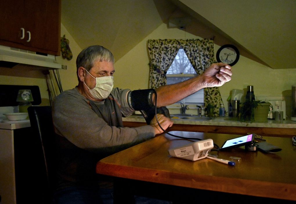 COVID-19 survivor Dean Cynor, 63, is treated through a telehealth program at his kitchen table in Bloomer, Wis., on Nov. 22, 2020. (Washington Post photo by Michael S. Williamson)