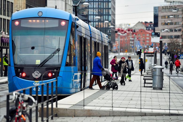 Commuters get off a tram in Stockholm, Sweden, on Nov. 11, 2020. On Thursday, Sweden rejected face masks even as COVID cases soared. (Bloomberg photo by Mikael Sjoberg)
