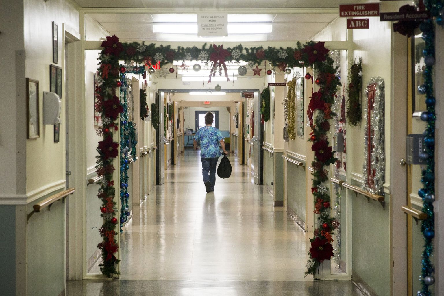 a nurse walks down a hall 