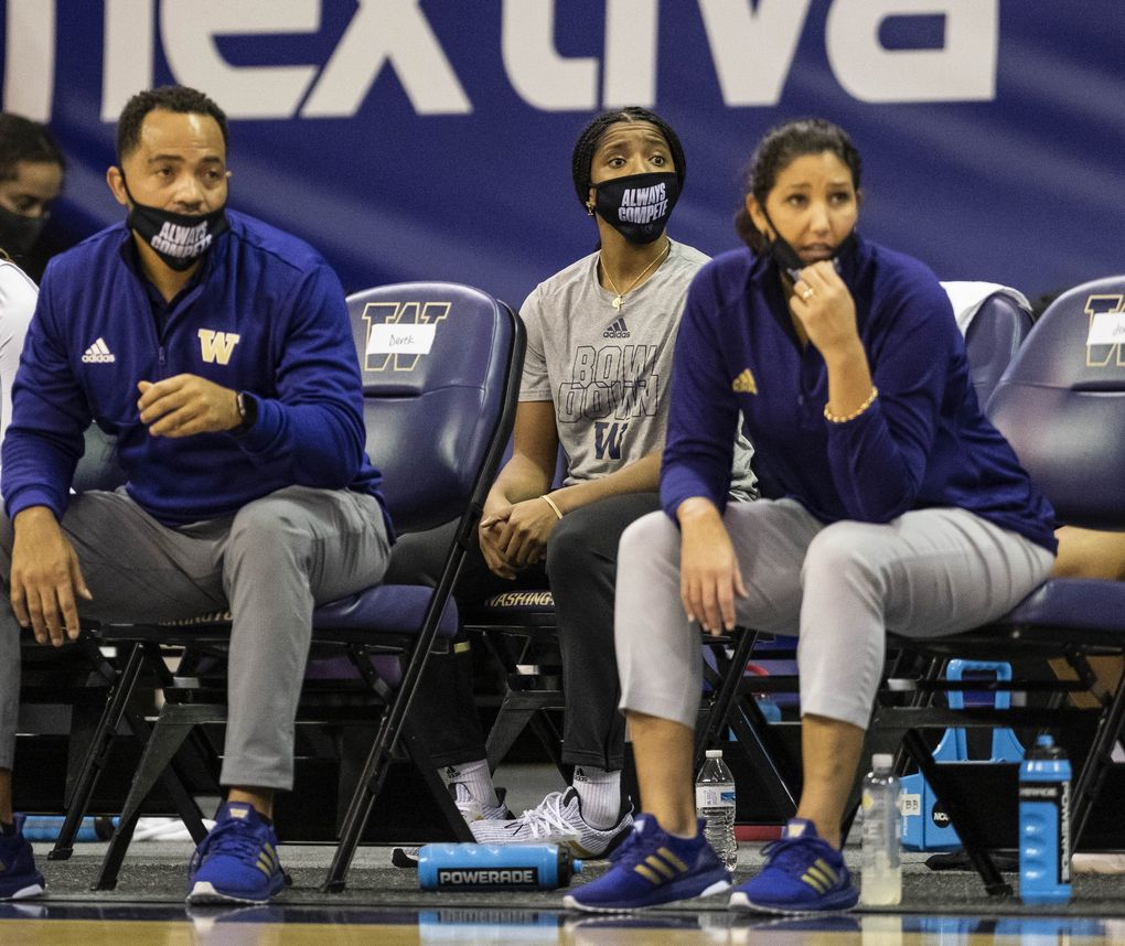 Tameiya Sadler (center) and coach Jody Wynn (right) are seen sitting on the bench during a UW women’s basketball game. (Dean Rutz / The Seattle Times)